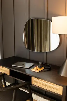 a desk with a mirror and a laptop on it at Sosuite at The Jefferson - Fishtown in Philadelphia