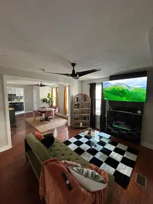 a living room with a couch and a flat screen tv at Collingdale Home - Near Philly! in Collingdale