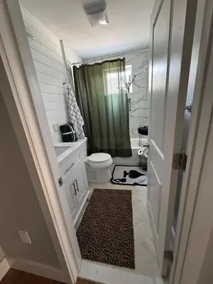 a bathroom with a toilet and a green shower at Collingdale Home - Near Philly! in Collingdale
