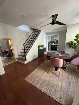 a living room with a table and chairs and a staircase at Collingdale Home - Near Philly! in Collingdale