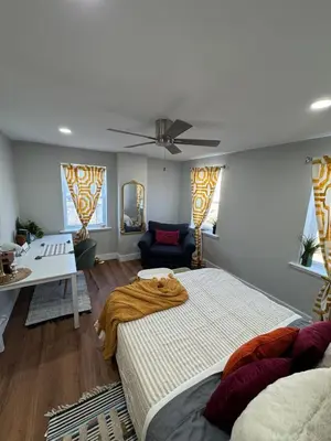 a bedroom with two beds and a ceiling fan at Collingdale Home - Near Philly! in Collingdale