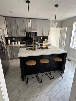 a kitchen with a large island with two stools at Collingdale Home - Near Philly! in Collingdale