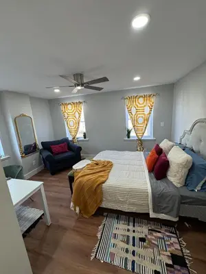 a bedroom with a bed and a couch at Collingdale Home - Near Philly! in Collingdale