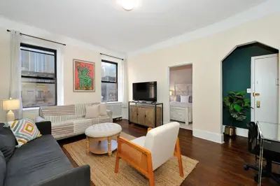 a living room with a couch and a tv at 5 Bedroom 2 Bath Full Floor Midtown in New York