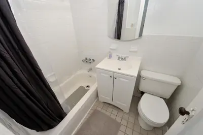 a bathroom with a toilet and a sink and a shower at 5 Bedroom 2 Bath Full Floor Midtown in New York