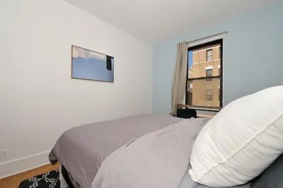 a bedroom with a bed and a window at 5 Bedroom 2 Bath Full Floor Midtown in New York
