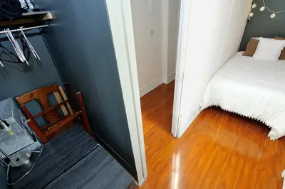 a bedroom with a bed and a chair in a room at 5 Bedroom 2 Bath Full Floor Midtown in New York