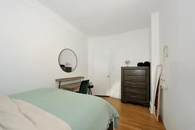 a bedroom with a bed and a mirror and a dresser at 5 Bedroom 2 Bath Full Floor Midtown in New York