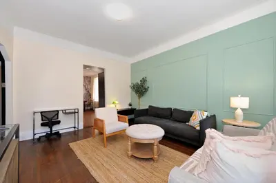 a living room with a couch and a table at 5 Bedroom 2 Bath Full Floor Midtown in New York