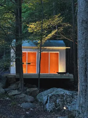 a house with orange doors in the woods at Ranch in the Woods, a Peaceful Designer Retreat in Warwick