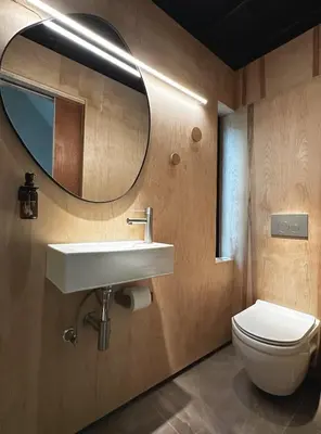 a bathroom with a sink and a toilet and a mirror at Ranch in the Woods, a Peaceful Designer Retreat in Warwick