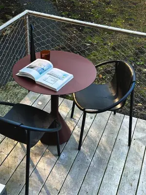 a table and two chairs with a book on it at Ranch in the Woods, a Peaceful Designer Retreat in Warwick