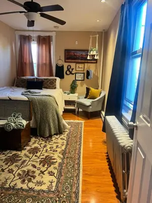 a bedroom with a bed and a living room at Cozy 1 bedroom Abode in Philadelphia