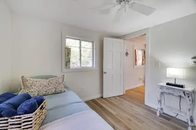 a living room with a couch and a table at Family Friendly Cabin With A Firepit And A Hot Tub In Heart of Poconos in Pocono Pines