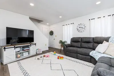 a living room with a couch and a flat screen tv at Serenity Inn in Ronks