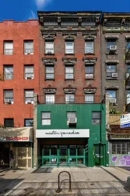 a large brick building with a green facade at 105- 4BRs in the Heart of the East Village in New York