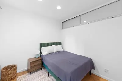 a bedroom with a bed with a light above it at 105- 4BRs in the Heart of the East Village in New York