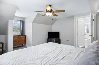 a bedroom with a bed and a ceiling fan at New House within Campground in Mifflinburg