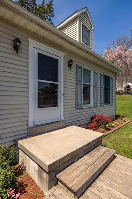 a house with a porch and a door at New House within Campground in Mifflinburg