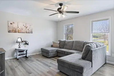 a living room with a couch and a ceiling fan at New House within Campground in Mifflinburg