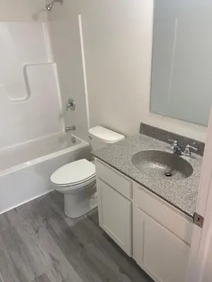 a white bathroom with a toilet and a sink at Warmth Private Room in Stillwater Lake Estates