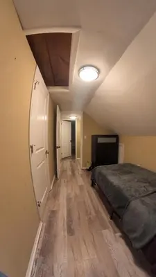 a bedroom with a bed and a hallway with a ceiling at 4Bedroom2Bath7GuestSleeper in Somerdale