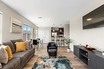 a living room with a couch and a dining room at City Views 1BR Free-Parking- Easy NYC Access in Newark
