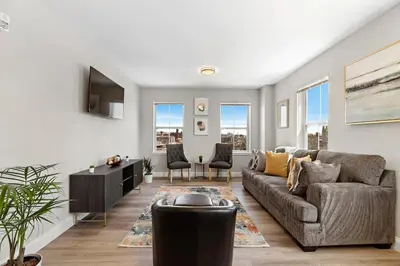 a living room with a couch and some windows at City Views 1BR Free-Parking- Easy NYC Access in Newark