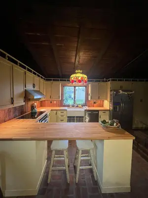 a kitchen with a large kitchen island with two bar stools at Homestead Upper Bucks - No Pet Fees in Perkasie