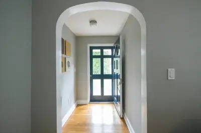 a hallway with an archway leading to a door at K9 Cottage MainLine in Berwyn