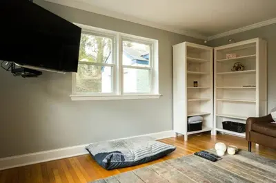 a living room with a flat screen tv and a couch at K9 Cottage MainLine in Berwyn