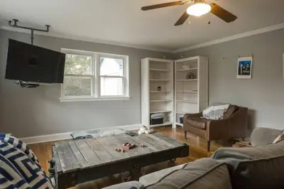 a living room with a couch and a coffee table at K9 Cottage MainLine in Berwyn