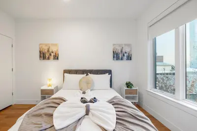 a bedroom with a large bed with a bow on it at Chic 1BR Retreat - Pool, Gym Balcony Views in Philadelphia