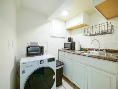 a kitchen with a washing machine and a sink at Cozy Studio Unit Close to New York City in Jersey City