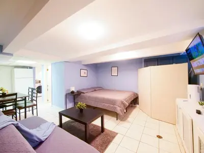 a living room with a bed and a table at Cozy Studio Unit Close to New York City in Jersey City