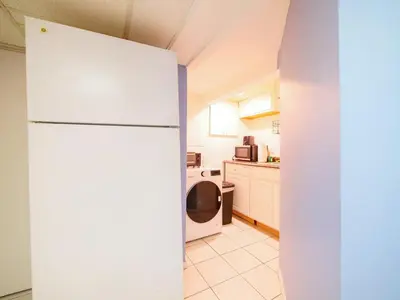 a kitchen with a white refrigerator in a room at Cozy Studio Unit Close to New York City in Jersey City