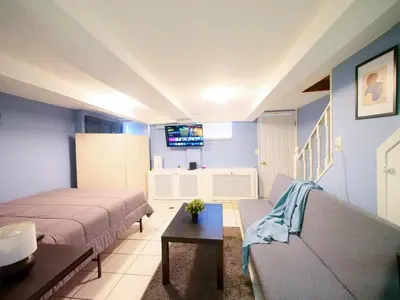 a living room with two beds and a couch at Cozy Studio Unit Close to New York City in Jersey City