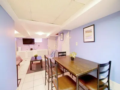 a dining room and living room with a table and chairs at Cozy Studio Unit Close to New York City in Jersey City