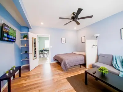 a living room with a bed and a couch at New Studio unit near the heart of NYC in Jersey City