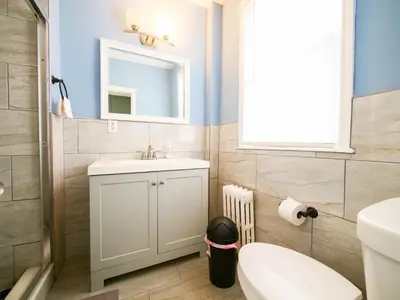a bathroom with a sink and a toilet and a mirror at New Studio unit near the heart of NYC in Jersey City
