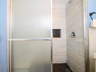a shower with a glass door in a bathroom at New Studio unit near the heart of NYC in Jersey City