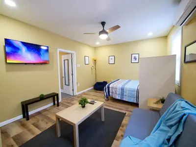 a living room with a couch and a bed at 2BED Cozy unit near NYC attractions in Jersey City