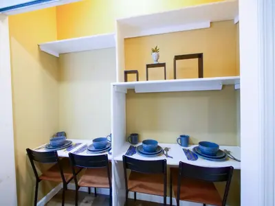 a dining room with a table and chairs with blue dishes at 2BED Cozy unit near NYC attractions in Jersey City