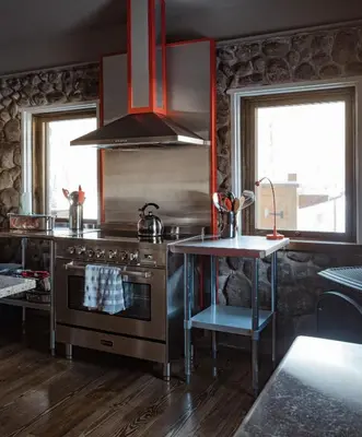 a kitchen with a stove and a table in it at Antrim Streamside in Livingston Manor