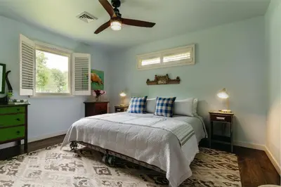 a bedroom with a bed and a ceiling fan at Antrim Streamside in Livingston Manor