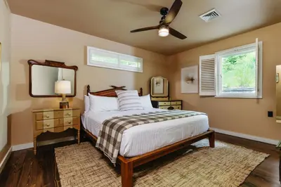 a bedroom with a bed and a ceiling fan at Antrim Streamside in Livingston Manor