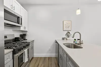 a kitchen with a sink and a stove at Free Parking 1BR Spacious BoHo 30Min to NYC in Bayonne
