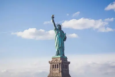 an image of the statue of liberty against a cloudy sky at Free Parking 1BR Spacious BoHo 30Min to NYC in Bayonne
