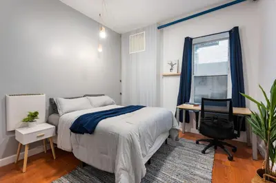 a bedroom with a bed and a desk and a window at 4 Bedroom 1 Bathroom Hudson Yard in New York