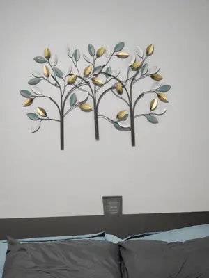 two trees on a wall above a bed at Comfy Fairmount in Newark